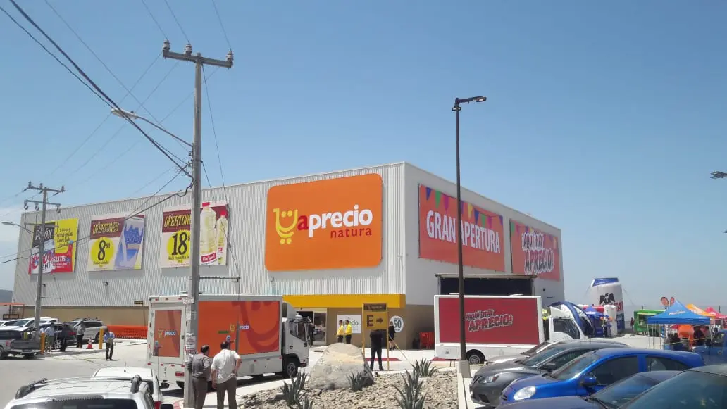 Two VIMEDIOS LED advertising trucks at a store opening in Tijuana